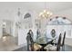 Well lit Dining room with modern chandelier, large window, and seating for six at 5051 Greenway Dr, North Port, FL 34287