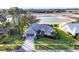 Charming home with well-manicured lawn, mature trees, and beautiful lake view at 5051 Greenway Dr, North Port, FL 34287
