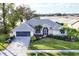 Beautiful single-story home with landscaped yard, and attached two-car garage at 5051 Greenway Dr, North Port, FL 34287