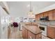 Open kitchen with tile flooring, center island, and stainless steel appliances at 5051 Greenway Dr, North Port, FL 34287