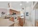 Well-lit kitchen with stainless steel appliances, tile floors, and center island at 5051 Greenway Dr, North Port, FL 34287