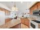 Bright kitchen with an island, tile floors, and stainless steel appliances at 5051 Greenway Dr, North Port, FL 34287