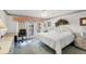 Comfortable bedroom featuring white king bed with doors to the pool at 5051 Greenway Dr, North Port, FL 34287