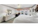 Comfortable bedroom featuring white king bed with doors to the pool at 5051 Greenway Dr, North Port, FL 34287
