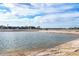 An inviting tranquil pond with sandy shoreline provides a serene view at 5051 Greenway Dr, North Port, FL 34287