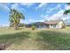 Wide shot of the backyard and pool area, landscaped with mature trees at 5061 Richmond Ter, North Port, FL 34287