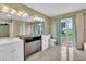 Spacious bathroom with double sinks, tile floors and natural light at 5061 Richmond Ter, North Port, FL 34287