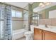 Cozy bathroom features a tub, shower, and a convenient shelving unit at 5061 Richmond Ter, North Port, FL 34287