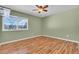 Bedroom featuring hardwood floors, large window and ceiling fan at 5061 Richmond Ter, North Port, FL 34287