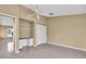 Bedroom with tile floor, ceiling fan, closet and built in shelves at 5061 Richmond Ter, North Port, FL 34287