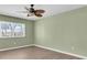 Bright bedroom with hardwood floors, ceiling fan and large window views at 5061 Richmond Ter, North Port, FL 34287
