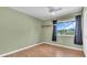 Relaxing bedroom with hardwood floors, large window and dark curtains at 5061 Richmond Ter, North Port, FL 34287