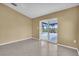 Neutral bedroom features tile flooring and a sliding glass door leading to the outdoor pool at 5061 Richmond Ter, North Port, FL 34287
