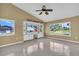 Spacious bonus room with vaulted ceilings, a ceiling fan, tile flooring, and large windows at 5061 Richmond Ter, North Port, FL 34287