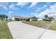 Inviting single-story home featuring a tile roof, well-manicured lawn, and a curving driveway at 5061 Richmond Ter, North Port, FL 34287