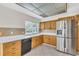Kitchen area featuring stainless steel refrigerator, black dishwasher and tile floor at 5061 Richmond Ter, North Port, FL 34287