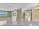 Open-concept living space with tile flooring, neutral paint, and sliding glass doors to a pool area at 5061 Richmond Ter, North Port, FL 34287