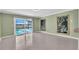 Bright living room featuring a sliding glass door to the lanai and pool, tile floors, and light green walls at 5061 Richmond Ter, North Port, FL 34287