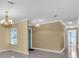 Bright and airy living room with tile floors, neutral walls, and a chandelier at 5061 Richmond Ter, North Port, FL 34287