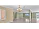 Spacious open-concept living area with tile flooring, decorative lighting, and multiple windows for natural light at 5061 Richmond Ter, North Port, FL 34287