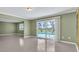 Open living space with tile flooring and views of the pool through sliding glass doors at 5061 Richmond Ter, North Port, FL 34287