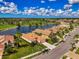 Aerial view of a home overlooking a large pond near a golf course at 5151 Pine Shadow Ln, North Port, FL 34287