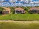 Beautiful backyard view with a well-manicured lawn and mature trees in a serene community at 5151 Pine Shadow Ln, North Port, FL 34287