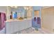 Main bathroom with double sinks, plenty of vanity storage space, and a tiled walk-in shower at 5151 Pine Shadow Ln, North Port, FL 34287