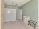 Spacious bedroom featuring neutral carpeting, a walk-in closet, and soothing green walls at 5151 Pine Shadow Ln, North Port, FL 34287