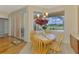 Charming breakfast nook boasts wood floors, natural light, and lovely outdoor views at 5151 Pine Shadow Ln, North Port, FL 34287