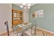 Dining room featuring a glass table, wooden floors, and a decorative hutch at 5151 Pine Shadow Ln, North Port, FL 34287