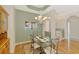 Dining room area featuring a modern chandelier, wooden floors, and decorative walls at 5151 Pine Shadow Ln, North Port, FL 34287