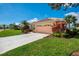 Exterior of house with a well-maintained lawn and a two car garage at 5151 Pine Shadow Ln, North Port, FL 34287