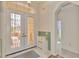 Bright foyer featuring double entry doors, tiled flooring, and a quaint chest of drawers at 5151 Pine Shadow Ln, North Port, FL 34287