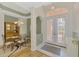 Foyer with double doors leading outside and dining room on the left at 5151 Pine Shadow Ln, North Port, FL 34287