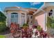 Close-up of home's entrance with decorative plantings at 5151 Pine Shadow Ln, North Port, FL 34287