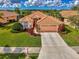 Beautiful single-story home with tile roof, manicured lawn, and two-car garage at 5151 Pine Shadow Ln, North Port, FL 34287