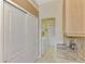 Hallway with closet and door leading to laundry room with newer washer and dryer at 5151 Pine Shadow Ln, North Port, FL 34287