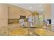 Bright kitchen with light wood cabinets, granite countertops and modern appliances at 5151 Pine Shadow Ln, North Port, FL 34287