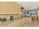 Beautiful kitchen with granite countertops, stainless steel appliances, and a sunny breakfast nook with lake view at 5151 Pine Shadow Ln, North Port, FL 34287