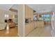 Well-lit kitchen with a breakfast bar and view of the screened lanai and water at 5151 Pine Shadow Ln, North Port, FL 34287