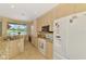 Eat-in kitchen with granite countertops, modern appliances, and a large window offering scenic views at 5151 Pine Shadow Ln, North Port, FL 34287