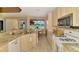 Well-appointed kitchen with granite counters, modern appliances, and a breakfast nook with views of the golf course at 5151 Pine Shadow Ln, North Port, FL 34287
