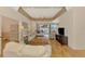 Bright living room with hardwood flooring, a ceiling fan, and sliders to the patio at 5151 Pine Shadow Ln, North Port, FL 34287