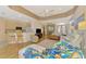 Bright living room featuring hardwood floors, a ceiling fan, and an open layout at 5151 Pine Shadow Ln, North Port, FL 34287