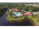 Aerial view of community pool, clubhouse, parking area, and surrounding ponds at 560 Misty Pine Dr, Venice, FL 34292