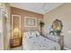 Comfortable bedroom with a cozy bed, decorative mirror, and charming decor at 560 Misty Pine Dr, Venice, FL 34292