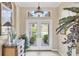 Bright foyer with double doors offering a view of the front yard, and elegant decor at 560 Misty Pine Dr, Venice, FL 34292