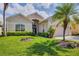 Lovely home with a manicured lawn, mature palm trees and a welcoming entrance at 560 Misty Pine Dr, Venice, FL 34292