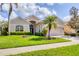 Charming single-story home with lush landscaping, a well-kept lawn, and a welcoming entrance at 560 Misty Pine Dr, Venice, FL 34292